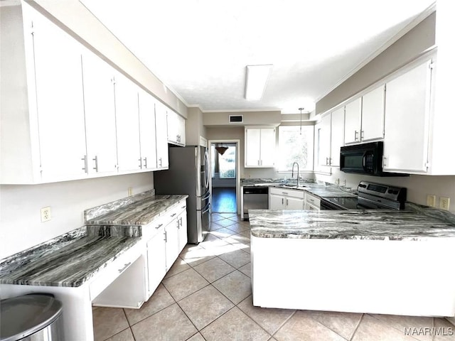 kitchen featuring white cabinets, light tile patterned floors, sink, and appliances with stainless steel finishes