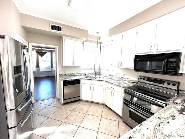 kitchen featuring light stone counters, stainless steel appliances, sink, light tile patterned floors, and white cabinets