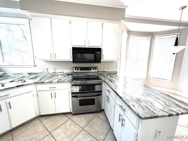 kitchen featuring pendant lighting, white cabinetry, and electric stove