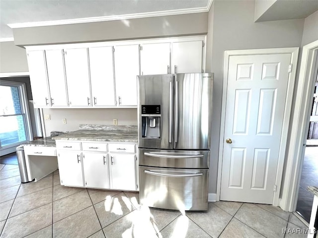 kitchen featuring light stone countertops, white cabinetry, stainless steel refrigerator with ice dispenser, and light tile patterned floors