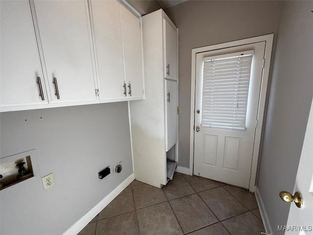 clothes washing area featuring hookup for a washing machine, tile patterned flooring, and cabinets