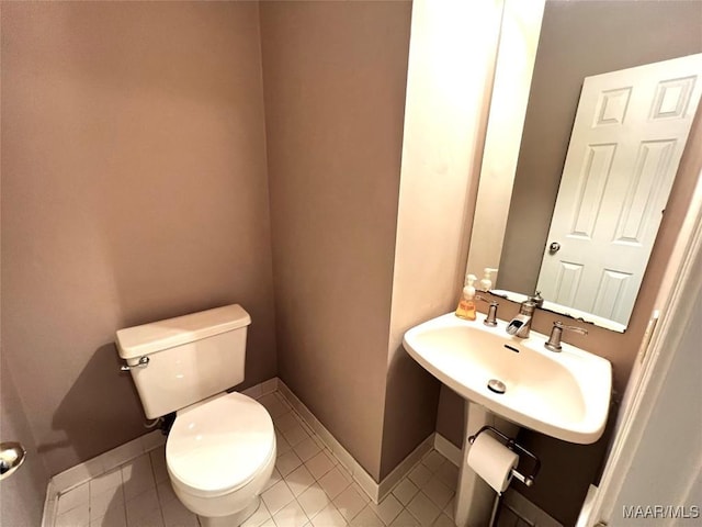 bathroom featuring sink, tile patterned flooring, and toilet