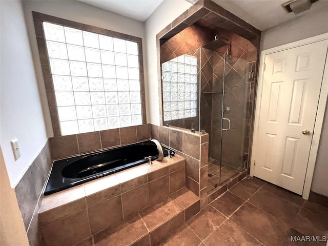 bathroom featuring plus walk in shower and tile patterned flooring