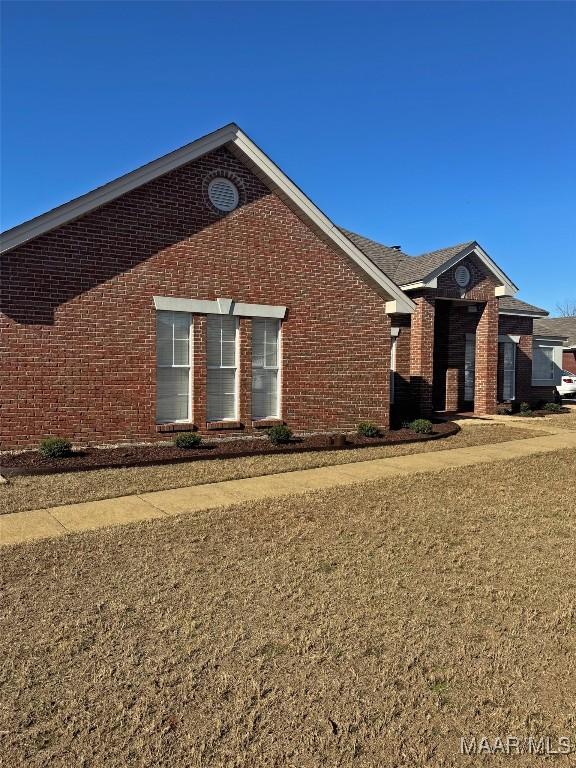 view of side of home featuring a lawn