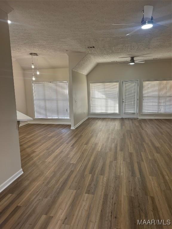 unfurnished living room featuring dark hardwood / wood-style flooring, a textured ceiling, ceiling fan, and lofted ceiling