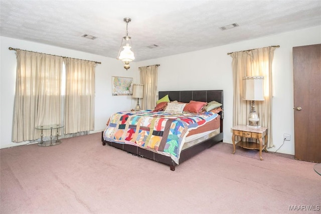 carpeted bedroom with a textured ceiling