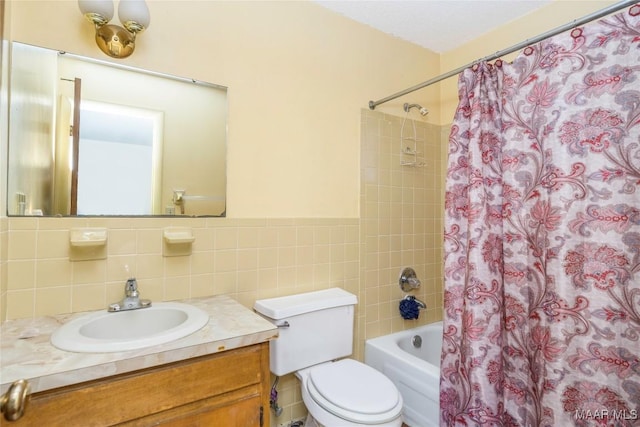 full bathroom featuring vanity, shower / bathtub combination with curtain, tile walls, and toilet