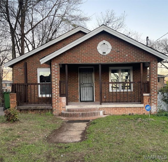 view of front of property featuring a porch and a front lawn