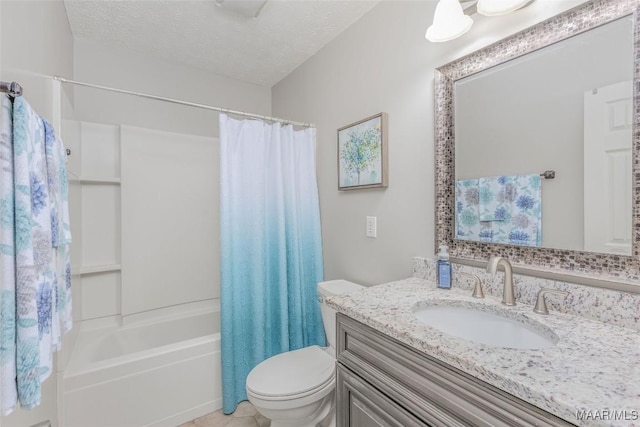 full bathroom featuring shower / bath combo with shower curtain, vanity, a textured ceiling, and toilet