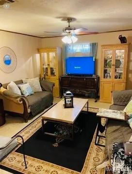 living room featuring ceiling fan and crown molding