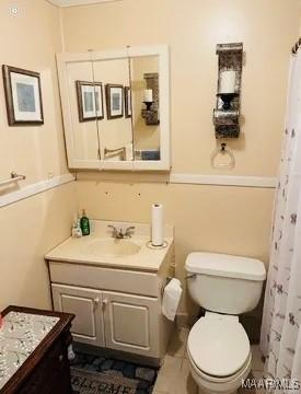 bathroom featuring tile patterned floors, vanity, toilet, and a shower with curtain