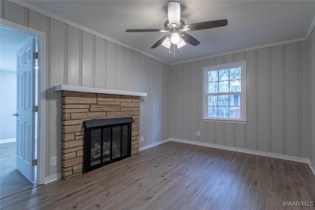 unfurnished living room with ceiling fan, a fireplace, wood-type flooring, and ornamental molding