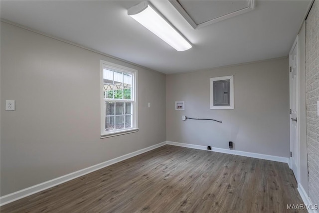 laundry room featuring electric panel, washer hookup, and wood-type flooring