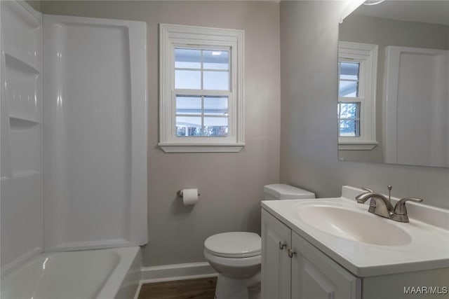 bathroom with vanity, toilet, and plenty of natural light