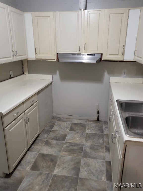 kitchen featuring white cabinets and sink