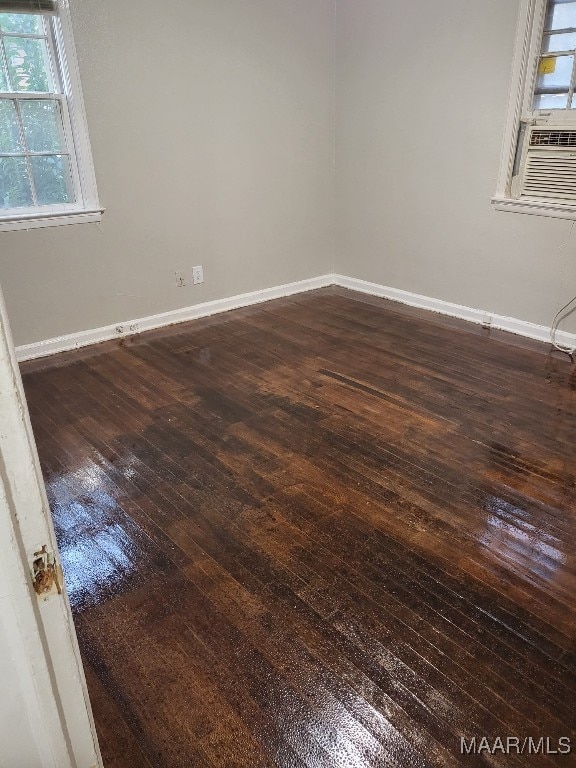 empty room with dark hardwood / wood-style floors and cooling unit