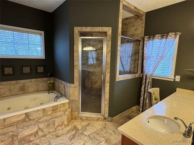 bathroom featuring vanity and shower with separate bathtub