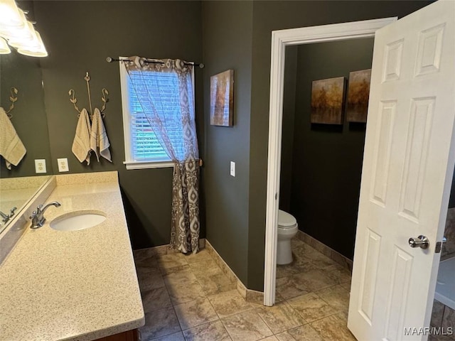 bathroom with vanity and toilet