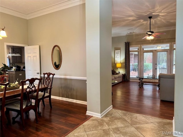 tiled dining space featuring ceiling fan, french doors, and ornamental molding