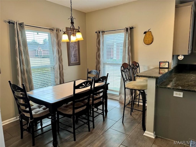 tiled dining space with an inviting chandelier