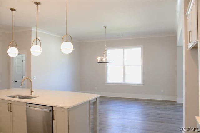 kitchen featuring pendant lighting, sink, ornamental molding, a kitchen island with sink, and stainless steel dishwasher