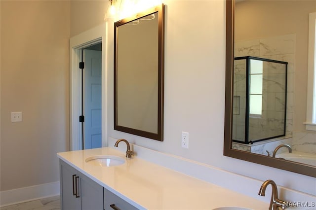 bathroom featuring a shower with door and vanity