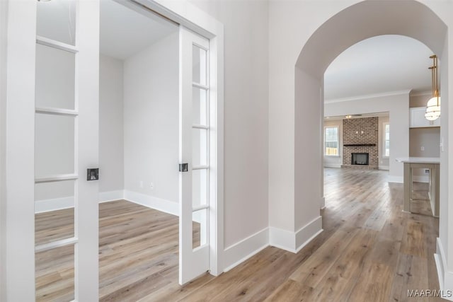 8325 Young Xing, Montgomery, AL 36116 - hallway with light wood-style flooring, arched walkways, and ornamental molding