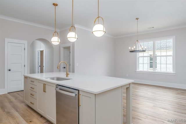 8325 Young Xing, Montgomery, AL 36116 - kitchen with stainless steel dishwasher, ornamental molding, light wood finished floors, a kitchen island with sink, and arched walkways