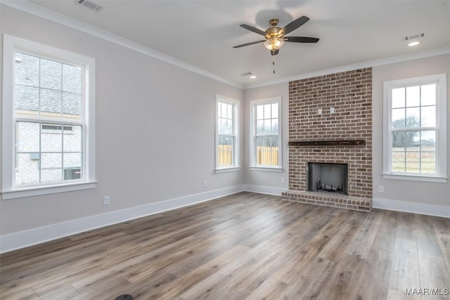 8325 Young Xing, Montgomery, AL 36116 - unfurnished living room featuring crown molding, wood finished floors, ceiling fan, and a fireplace