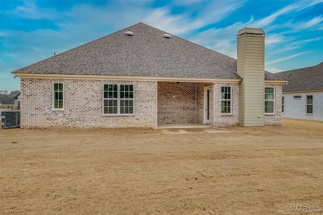 8325 Young Xing, Montgomery, AL 36116 - rear view of property featuring brick siding, roof with shingles, a patio, and a chimney