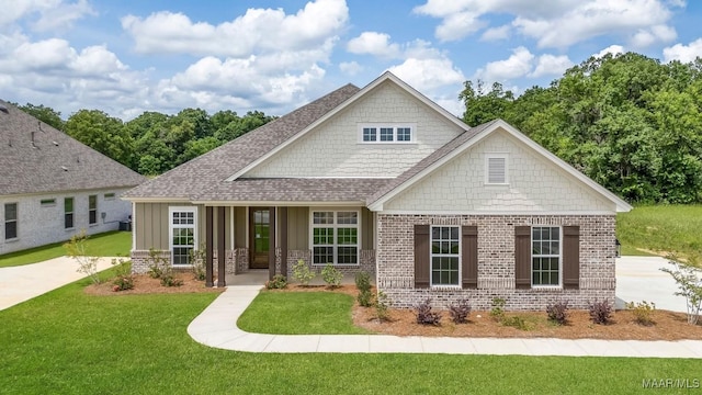 8325 Young Xing, Montgomery, AL 36116 - craftsman house with brick siding, a front lawn, a shingled roof, and board and batten siding