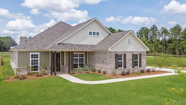 8325 Young Xing, Montgomery, AL 36116 - craftsman-style home featuring a front lawn, brick siding, a shingled roof, a chimney, and board and batten siding