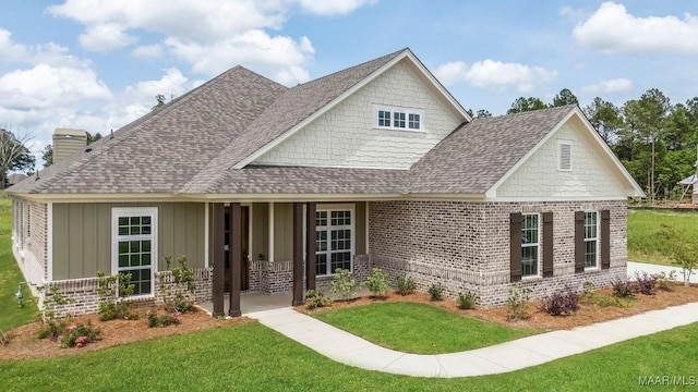 8325 Young Xing, Montgomery, AL 36116 - view of front of home featuring covered porch, brick siding, a front lawn, and a shingled roof