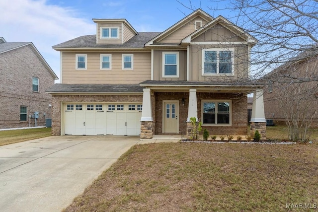 craftsman house with a porch, a garage, and a front lawn