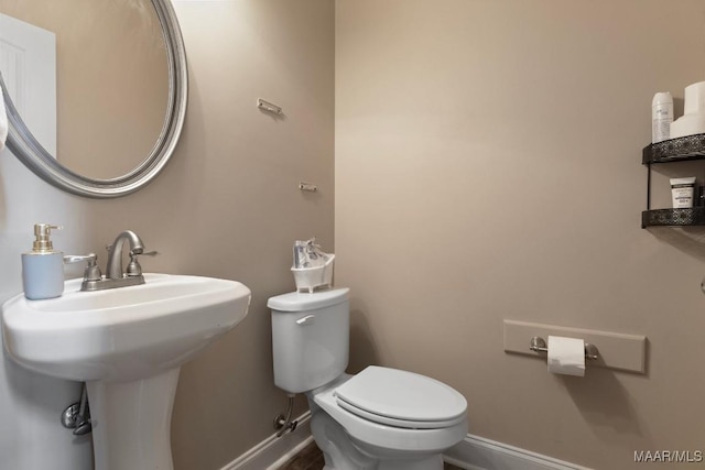 bathroom featuring toilet and sink