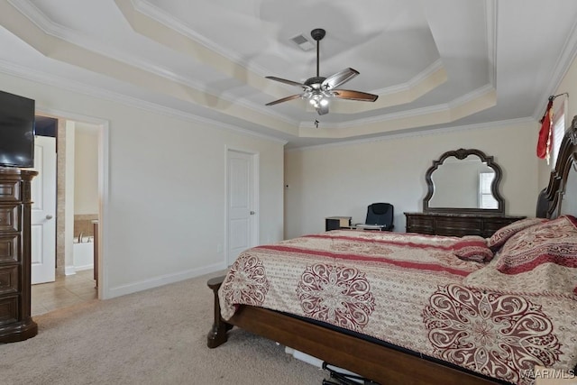 carpeted bedroom with ceiling fan, a raised ceiling, ornamental molding, and connected bathroom