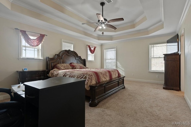 carpeted bedroom featuring ceiling fan, a raised ceiling, and crown molding