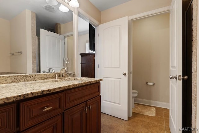 bathroom with tile patterned floors, vanity, and toilet