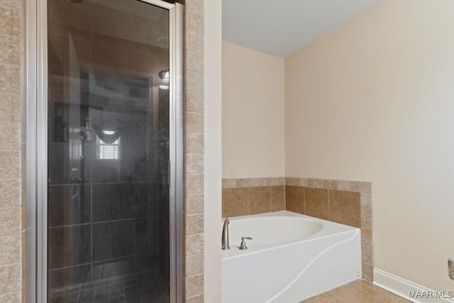 bathroom with tile patterned flooring and separate shower and tub