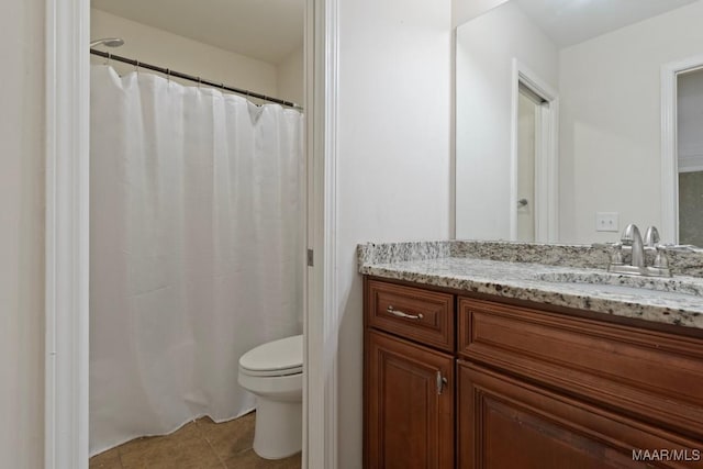 bathroom featuring tile patterned flooring, vanity, and toilet