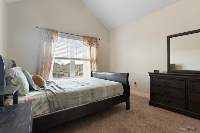 carpeted bedroom with high vaulted ceiling