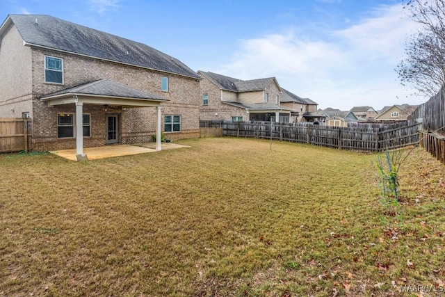 view of yard with ceiling fan and a patio area