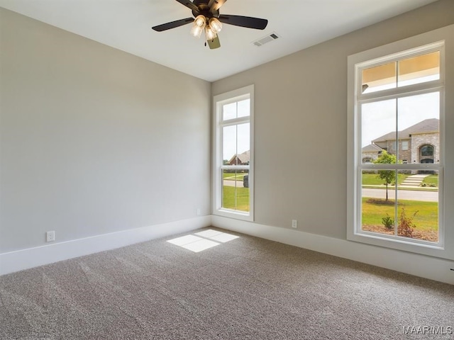 carpeted spare room with ceiling fan