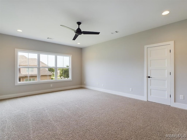 carpeted spare room with ceiling fan