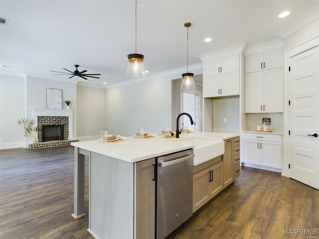 kitchen with white cabinetry, sink, an island with sink, and dishwasher