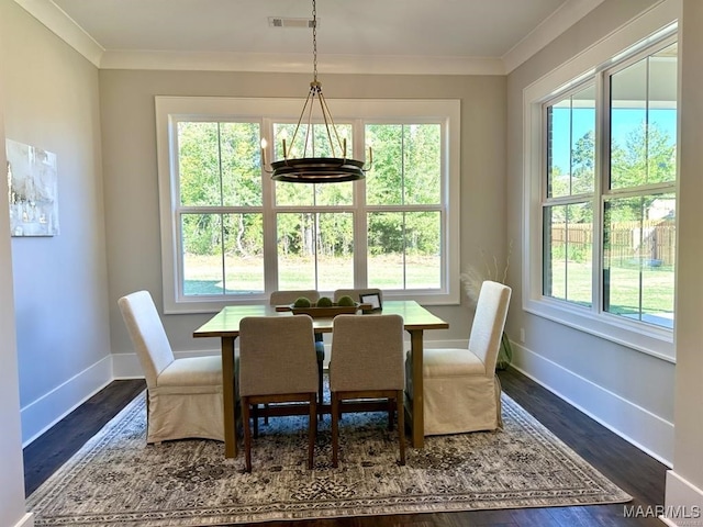 dining room with crown molding and dark hardwood / wood-style flooring