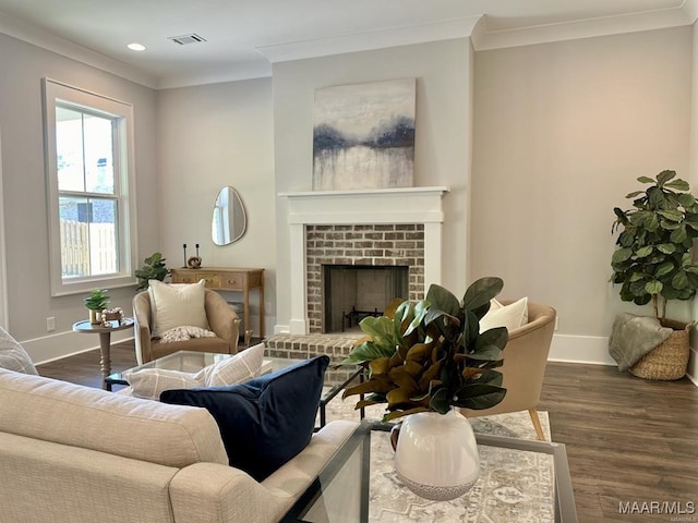 living room featuring crown molding, dark hardwood / wood-style flooring, and a brick fireplace