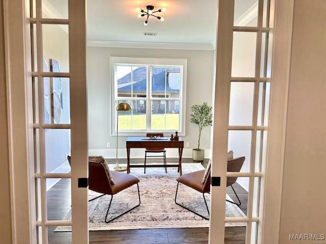 interior space featuring hardwood / wood-style flooring, ornamental molding, and french doors