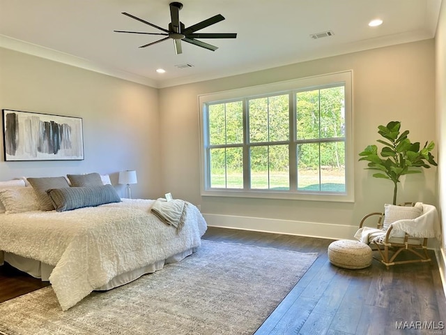 bedroom featuring dark wood-type flooring, ceiling fan, and crown molding