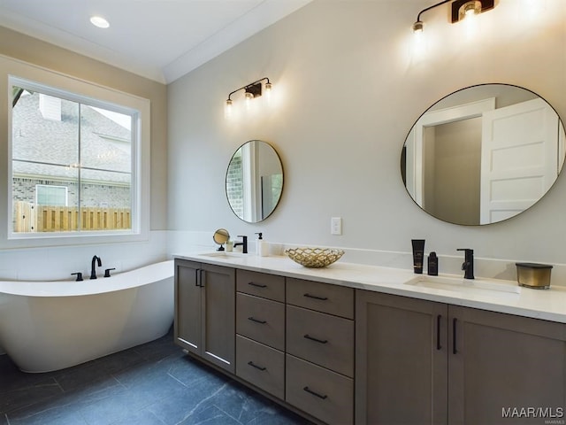 bathroom featuring crown molding, vanity, and a tub